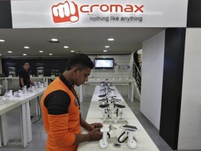 An employee stands at the counter of Micromax mobile phones at a showroom in New Delhi